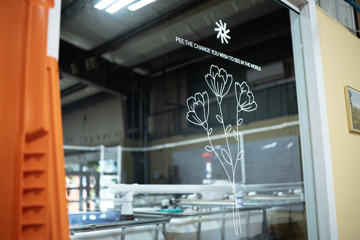 Lab window with the words "Pee the change you want to see in the world"